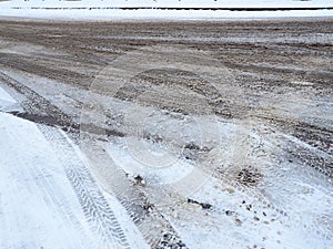 A fork or siding from a roundabout. Snowdrifts on the side of the road. Bad weather. Snow on asphalt. Difficult driving