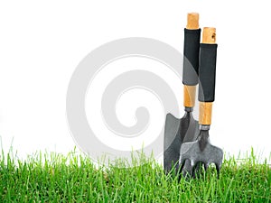 Fork and spade on the green grass