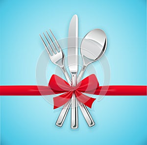 Fork, spoon, knife with red bow. Set of utensils for eating.