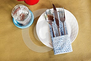 Fork-spoon-knife on white plate