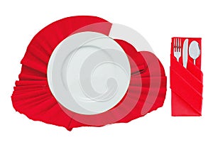 Fork, spoon, knife and white plate on red cloth isolated on whit