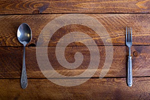 Fork, spoon, knife on the wooden table background with copy place. Concept kitchen and restaurant service. Top view