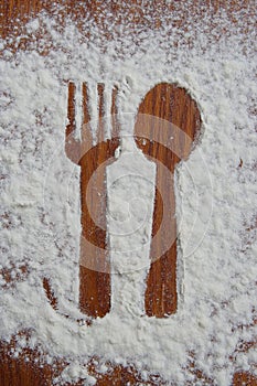 Fork and a Spoon shadow. Fork and a Spoon made of sugar powder.