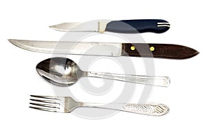 Fork, spoon and two knives on a white background