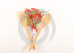 Fork spoon on white background with red hot chilis pepper. Top