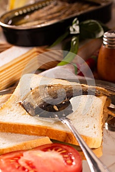 Fork for sprat with fish on a piece of bread