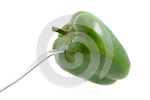 Fork sticked in green pepper