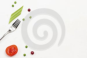 Fork, tomato, cranberry and celery stems on white background