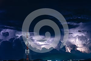 Forked lightning over the cell phone antenna tower at night