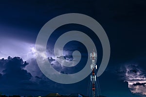 Forked lightning over the cell phone antenna tower at night