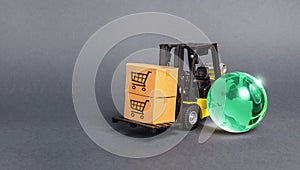 Forklift with boxes and a bright green glass globe. The concept of commerce and trade, cargo delivery, exchange of goods