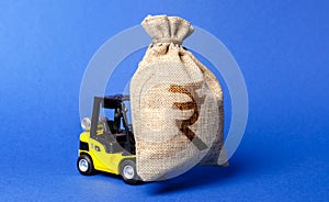 A forklift carries a huge money bag with the symbol of the Indian rupee. Budget and corruption, investment and economic growth. photo