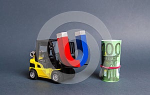 A forklift carries a magnet to a bundle of Euro. Attracting money and investments for business purposes and startups. Increase