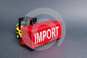 A forklift carries a red freight container labeled Import. The concept of import of goods, transport services and nodes. Cargo