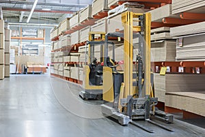 forklift in a construction shop. Construction Materials. Stacking truck in wholesale warehouse photo