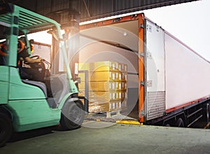 Forklift Driver Loading Package Boxes into Cargo Container. Cargo Trailer Truck Parked Loading at Dock Warehouse. photo