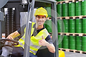 Forklift driver in a logistics hall of a chemical warehouse