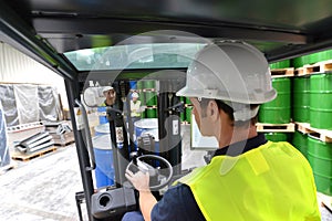 Forklift driver in a logistics hall of a chemical warehouse