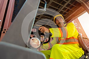 Forklift driver man worker staff working loading container cargo in shipping yard logistics employee work man Asian country