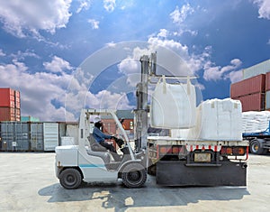 Forklift driver moving big bag to the truck at yard.