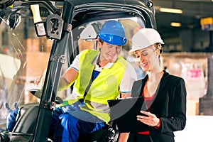 Forklift driver and supervisor at warehouse