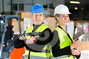 Forklift driver and supervisor at warehouse