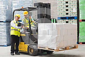 Forklift driver talking with his manager