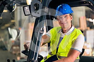 Forklift driver at warehouse of forwarding photo