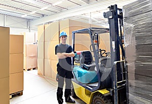 Forklift driver in a warehouse for industrial goods