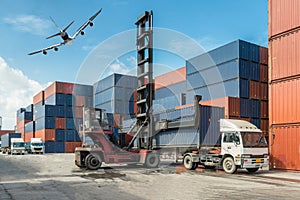 Forklift handling container box loading at docks with truck for