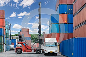 Forklift handling container box loading at docks with truck for