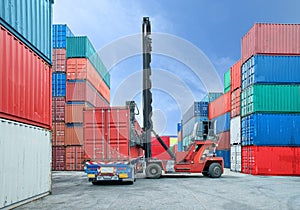 Forklift handling container box loading to truck in dock