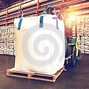 Forklift handling jumbo sugar bag for stuffing into container for export. Distribution, Logistics Import Export.