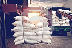 Forklift handling white sugar bag from warehouse for stuffing into container for export, vintage color