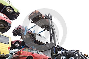 Forklift hoisting car wrecks photo