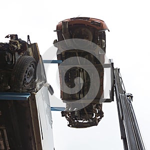 Forklift hoisting car wrecks photo