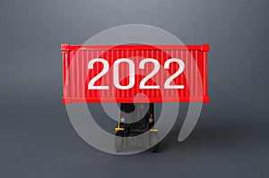 Forklift holds a container with 2022. Analytics forecasting of freight traffic next year. Express air delivery, goods