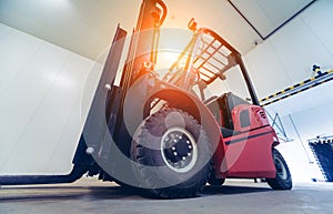 Forklift in a large industrial freezer warehouse.