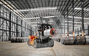 Forklift lift heavy steel coil inside warehouse at a seaport bounded area. Raw material handling and transportation. photo