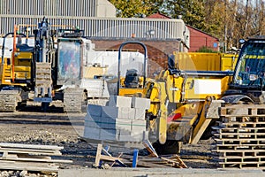 Forklift lifting and moving bricks on a pallet on construction site. Moving concrete block with a telehandler