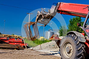 Forklift lifts the rebar bundle from ground on building site