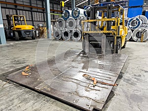 Forklift loader. Iron pallet equipment at warehouse. roll steel Background