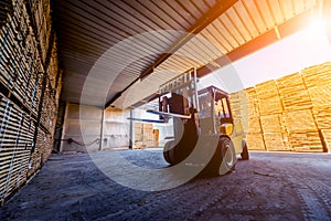 Forklift loader load lumber into a dry kiln. Wood drying in containers.