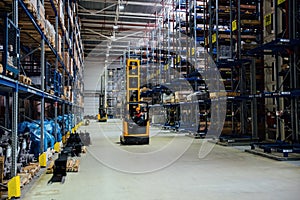 Forklift loader in Modern warehouse interior with shelves and boxes