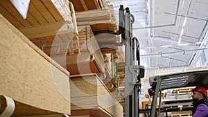 Forklift loader in storage lumber warehouse. Distribution products. Delivery. Logistics. Transportation
