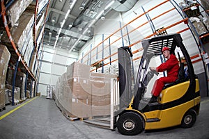 Forklift loader working in warehouse