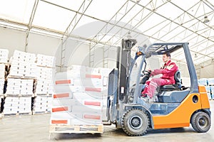 Forklift loader working in warehouse