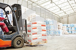 Forklift loader working in warehouse