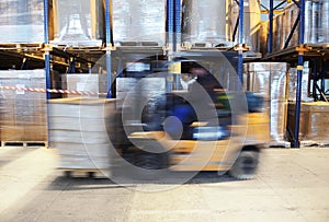 Forklift in motion at warehouse