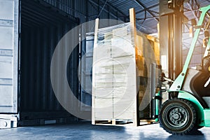 Forklift Tractor Loading Package Boxes into Container Truck. Warehouse Shipping. Freight Truck Transport Logistic